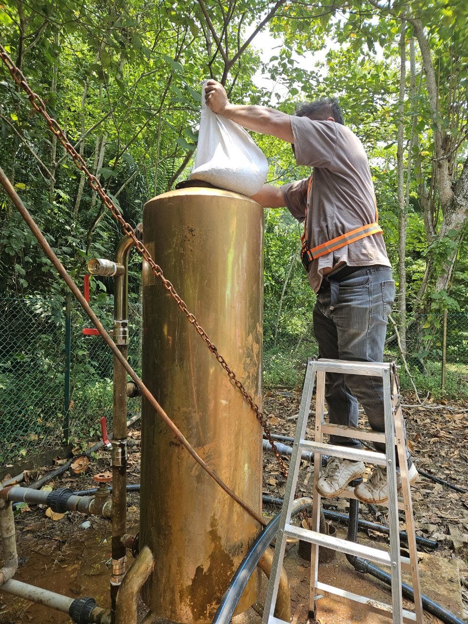 Technician loading replacement media into filter